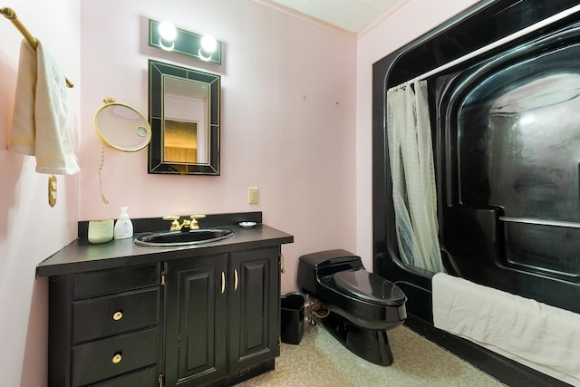 bathroom with vanity, toilet, and ornamental molding