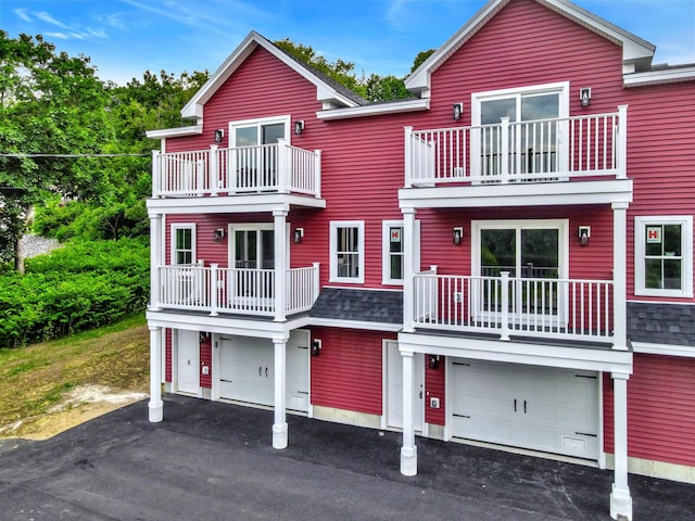 view of front facade with a garage and a balcony