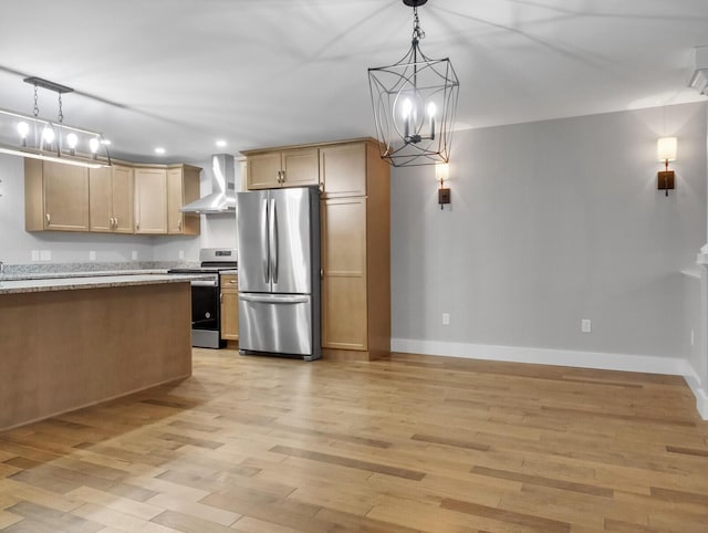 kitchen featuring wall chimney exhaust hood, hanging light fixtures, appliances with stainless steel finishes, and light hardwood / wood-style flooring