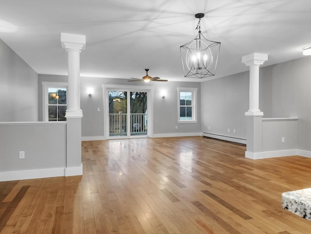 unfurnished living room with baseboard heating, light hardwood / wood-style floors, and ceiling fan with notable chandelier