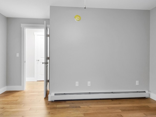 unfurnished room featuring light hardwood / wood-style floors and baseboard heating