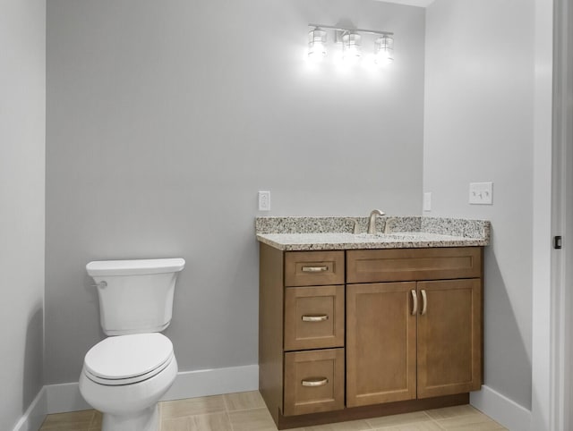 bathroom featuring tile patterned floors, vanity, and toilet