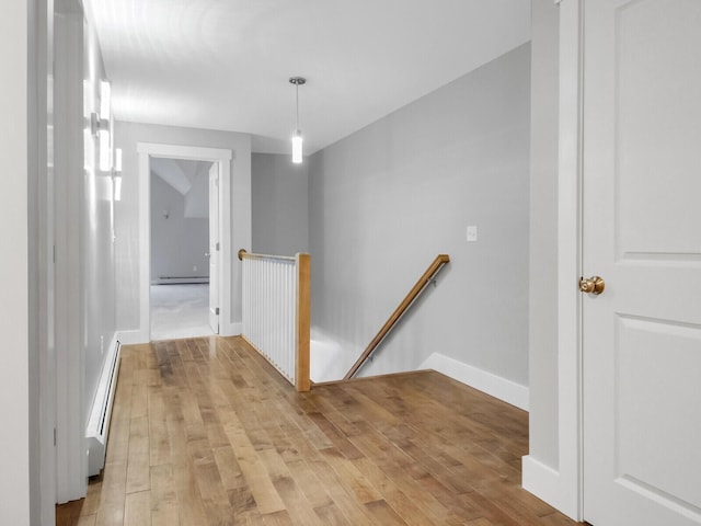 hall with light wood-type flooring and baseboard heating