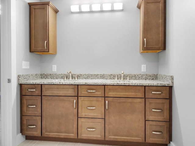 bathroom with tile patterned flooring and vanity