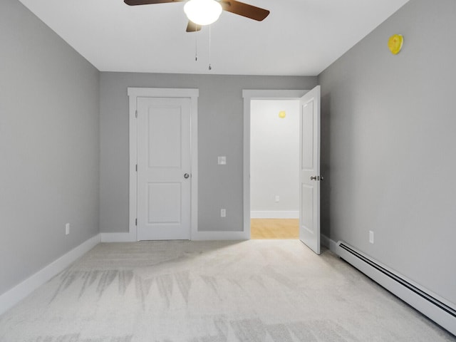 unfurnished bedroom featuring ceiling fan, light colored carpet, and a baseboard radiator