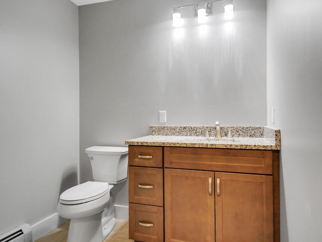 bathroom with vanity, a baseboard radiator, and toilet