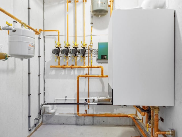 utility room featuring water heater