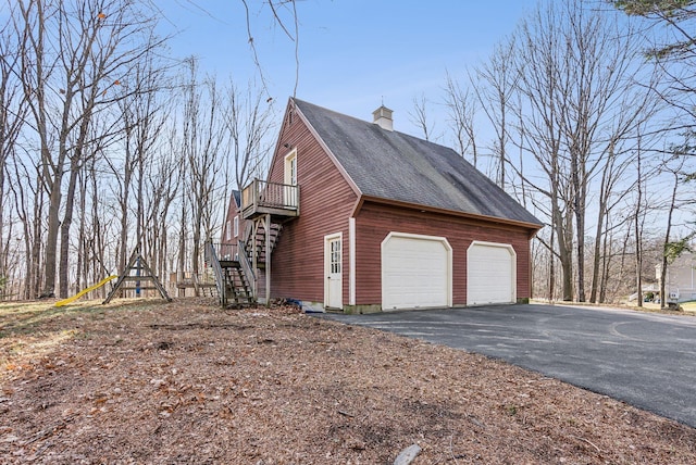 view of side of home with a balcony and a garage