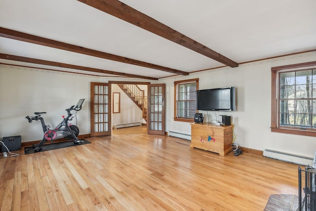 interior space with light hardwood / wood-style floors, french doors, and a baseboard radiator