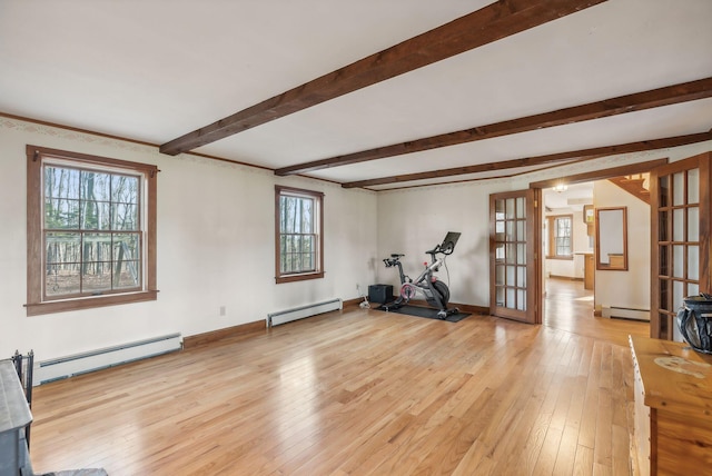 exercise room with french doors, light hardwood / wood-style flooring, and a baseboard heating unit