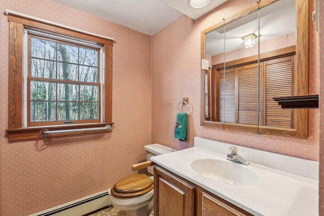 bathroom featuring vanity, toilet, and a baseboard radiator