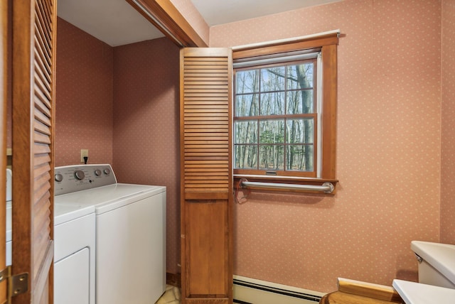 clothes washing area featuring washing machine and dryer and a baseboard radiator