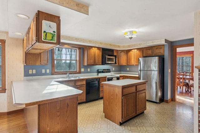 kitchen featuring a center island, stainless steel appliances, and sink