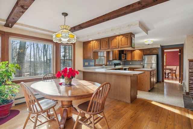 kitchen featuring light hardwood / wood-style flooring, hanging light fixtures, plenty of natural light, and sink