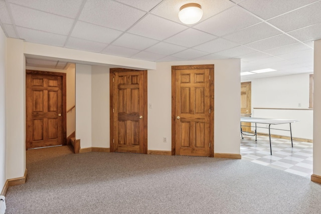 interior space featuring a drop ceiling and light colored carpet