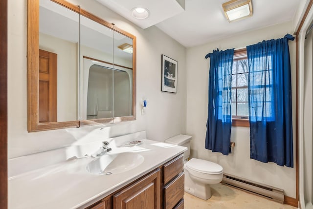 bathroom with vanity, toilet, and a baseboard heating unit