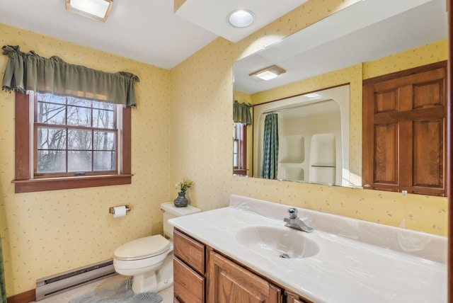 bathroom with vanity, toilet, and baseboard heating