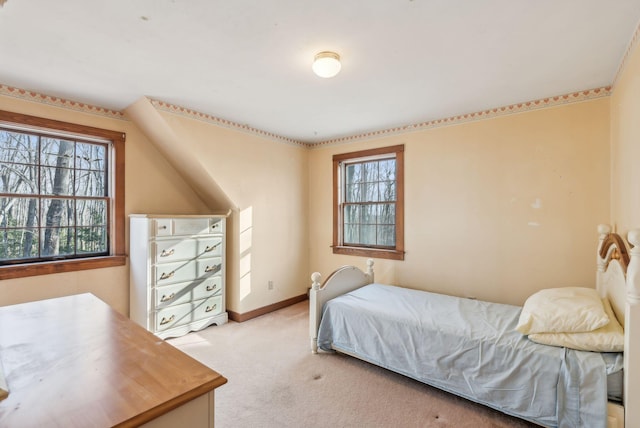 bedroom with multiple windows and light colored carpet