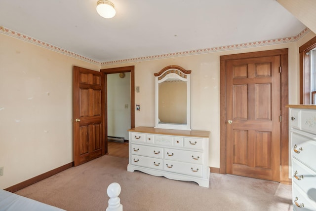 unfurnished bedroom with light carpet and a baseboard radiator