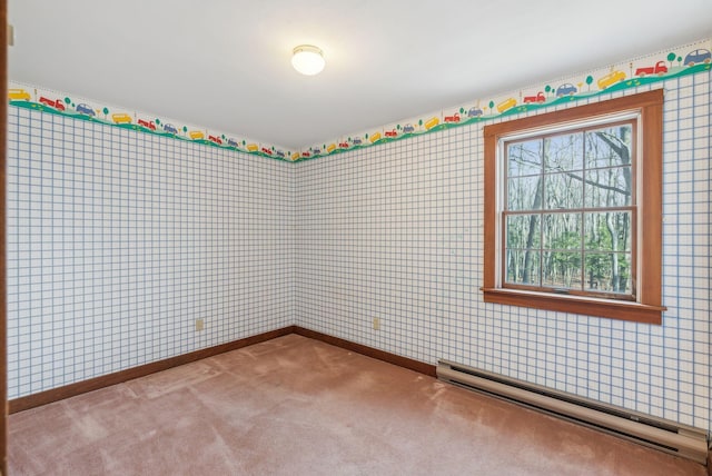 carpeted spare room featuring baseboard heating