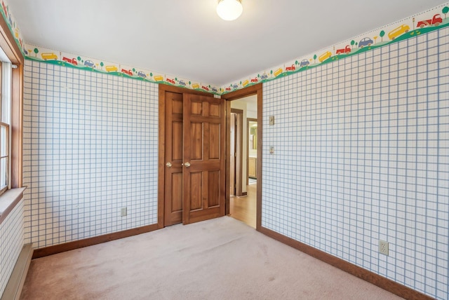 unfurnished bedroom featuring light colored carpet