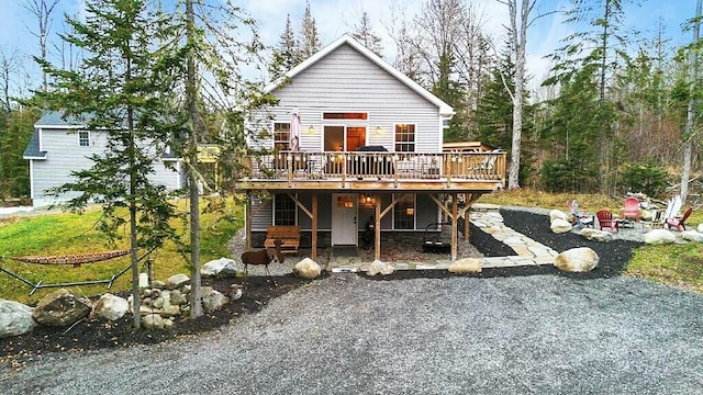 rear view of property featuring a deck