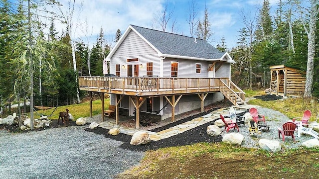 rear view of property with a fire pit and a deck