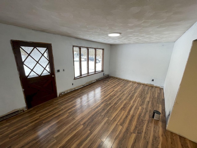 entrance foyer featuring dark hardwood / wood-style flooring and a textured ceiling