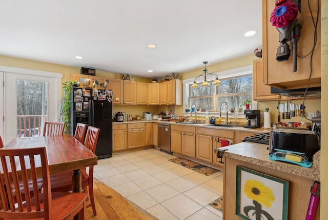 kitchen featuring sink, black fridge, decorative light fixtures, light brown cabinetry, and light tile patterned floors