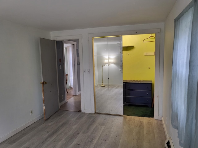 unfurnished bedroom featuring a closet and light hardwood / wood-style flooring