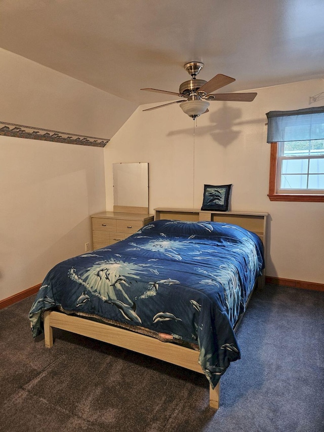 carpeted bedroom featuring baseboards, lofted ceiling, and a ceiling fan