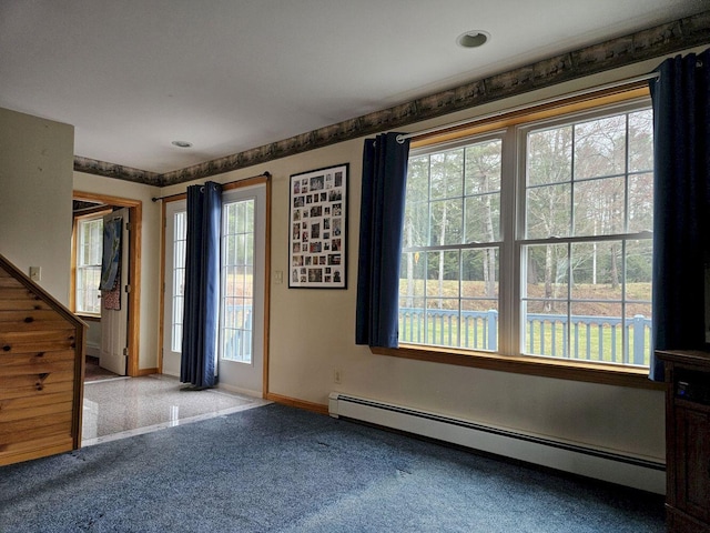 carpeted spare room with baseboards and a baseboard radiator