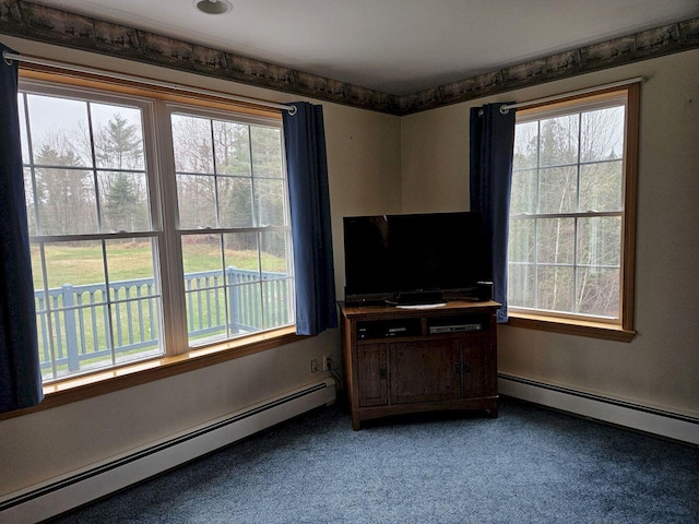 interior space featuring a wealth of natural light, carpet floors, and baseboard heating