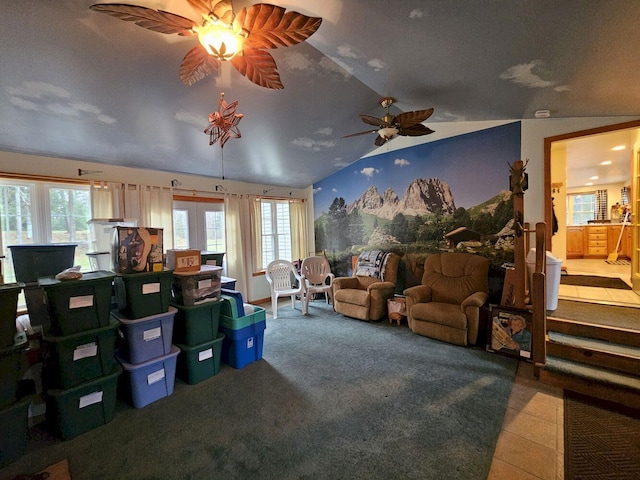 living room featuring lofted ceiling, tile patterned floors, ceiling fan, and plenty of natural light