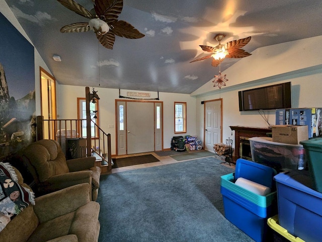 living room featuring lofted ceiling, stairs, ceiling fan, and carpet