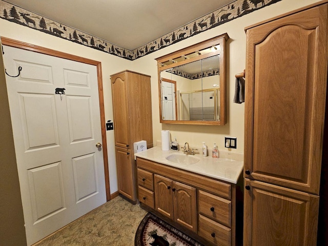 full bath with a shower with shower door and vanity