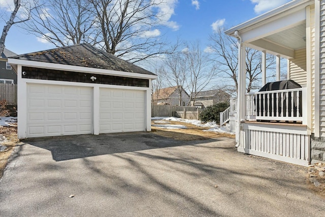 detached garage featuring fence