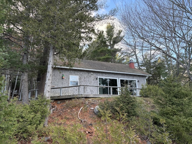 rear view of property with a wooden deck