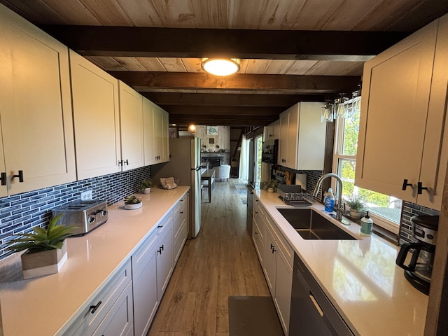 70 Hall Quarry Rd, Mount Desert, ME 04660 - kitchen with a sink, wood ceiling with exposed beams, light wood finished floors, light countertops, and backsplash
