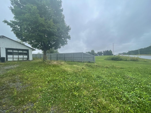 view of yard with an outbuilding and a water view