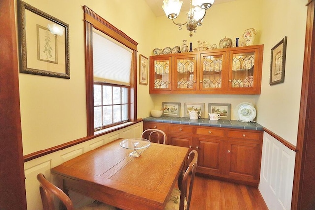 dining area featuring dark wood-type flooring and a notable chandelier