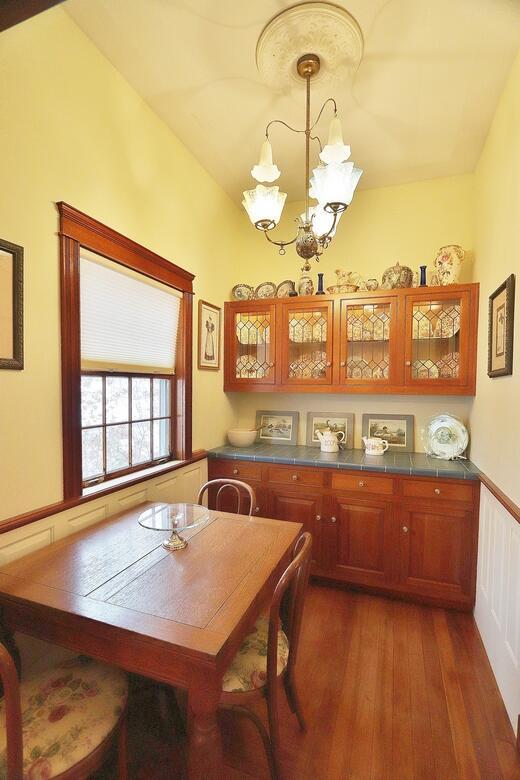 dining area with lofted ceiling, an inviting chandelier, and dark wood-type flooring