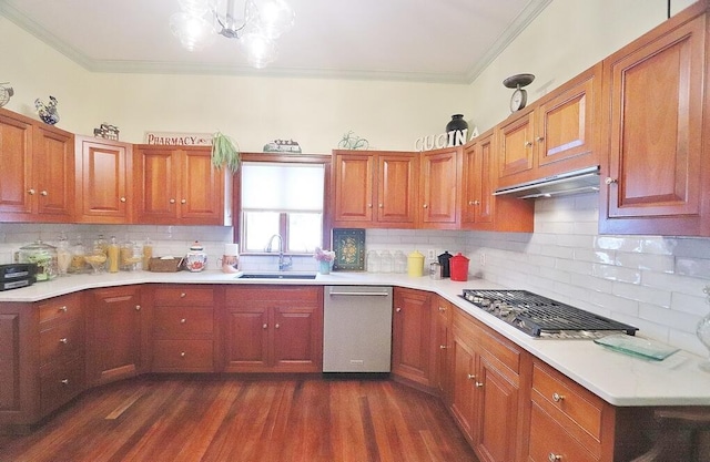 kitchen with backsplash, stainless steel appliances, ornamental molding, and sink