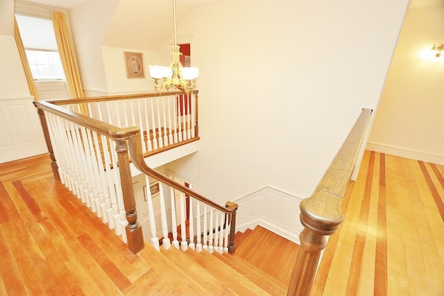 stairs featuring a chandelier