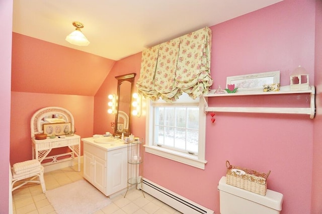 bathroom with tile patterned floors, vanity, baseboard heating, toilet, and lofted ceiling