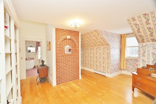 interior space featuring hardwood / wood-style flooring, sink, and a baseboard heating unit