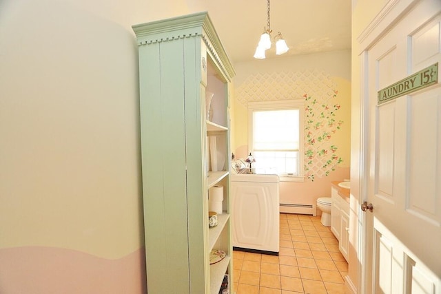 interior space featuring tile patterned flooring, a notable chandelier, toilet, and a baseboard heating unit