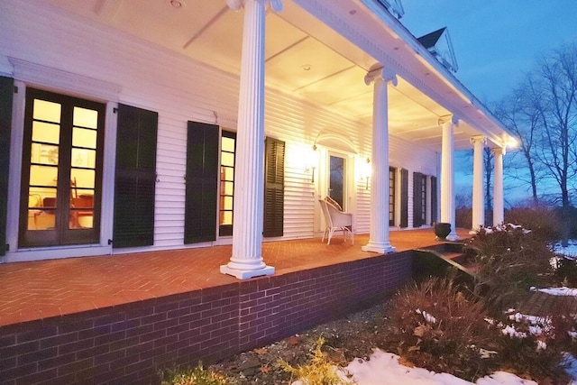 view of side of property featuring covered porch