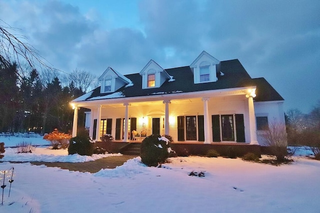 snow covered house with a porch