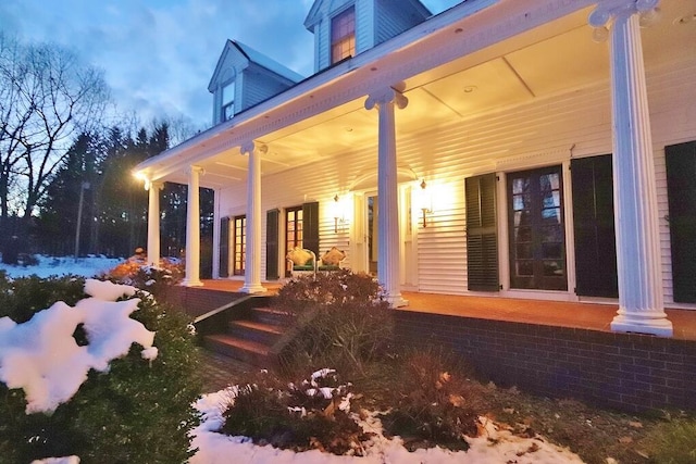 view of snowy exterior with a porch